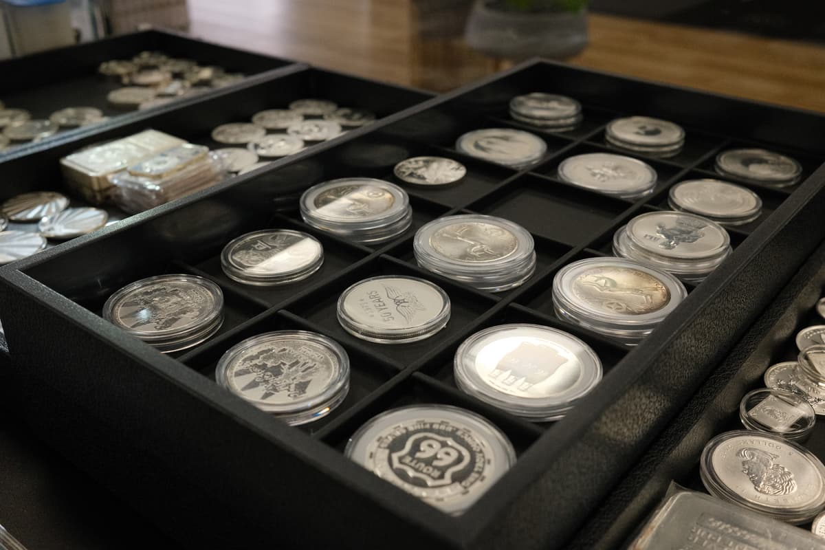 Staff evaluating precious metals at the counter at Gold & Diamond Company in Fayetteville, Arkansas