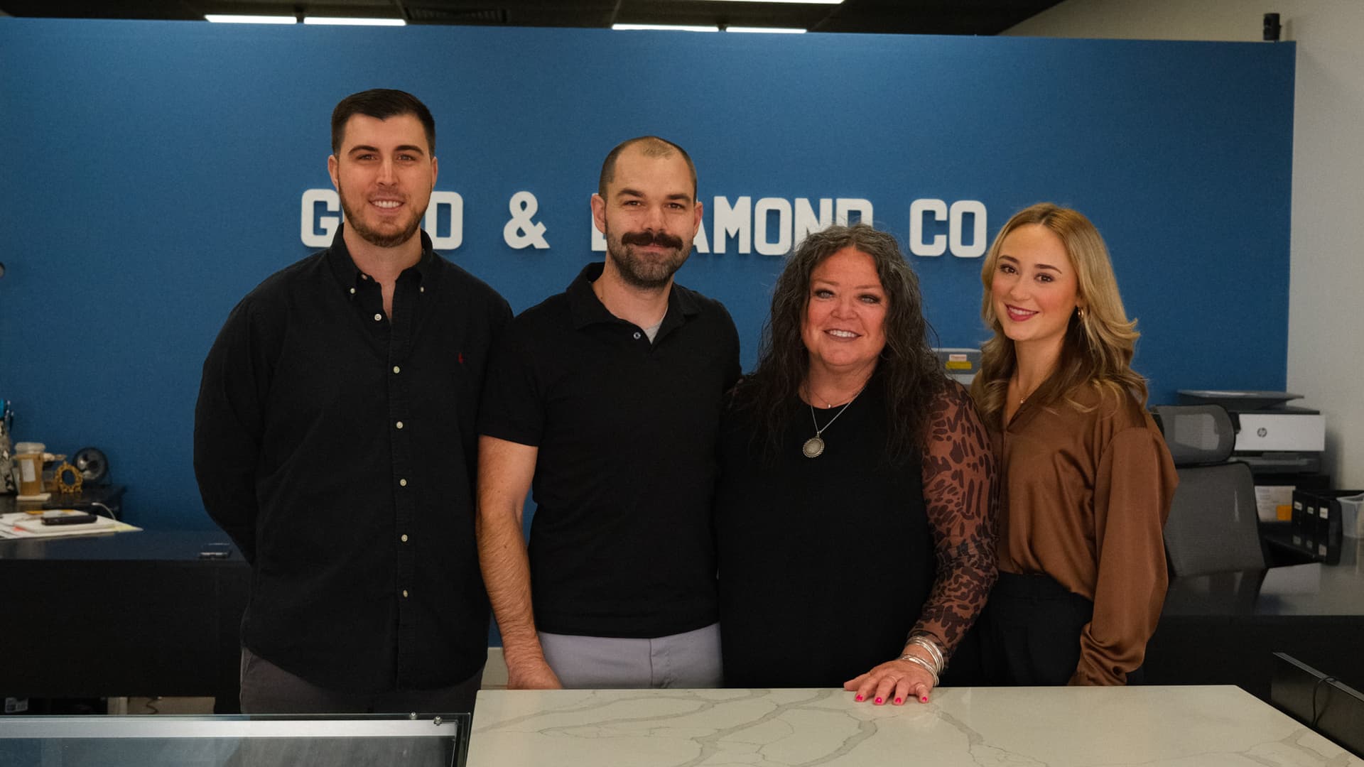 Gold & Diamond Company team of four behind the showroom counter in Rogers, Arkansas